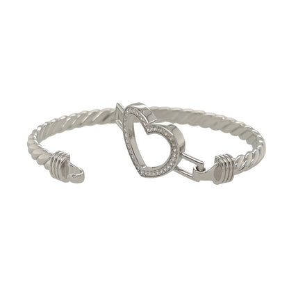 This new 925 sterling silver cubic zirconia set open heart twisted bangle is a stylish design, featuring an open heart centrepiece with stone detailing.

Design: Featuring a twisted bangle design with an open heart centrepiece, this bangle has a polished silver finish with cubic zirconia detailing.
Material: Made from 925 sterling silver.
Gemstone Detail: Set with cubic zirconia stones across the open heart design.
Bangle Detail: The front of the bangle measures approximately 21mm high.