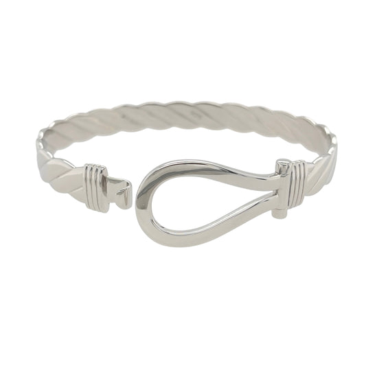 This new 925 sterling silver horseshoe twisted bangle is a substantial design, featuring a traditional horseshoe centrepiece with a decorative twisted profile.

Design: Featuring a twisted bangle design with a horseshoe centrepiece, this bangle has a polished silver finish with a bold and traditional appearance.
Material: Made from 925 sterling silver.
Bangle Detail: The horseshoe front measures approximately 20mm high, complemented by the twisted design of the bangle.