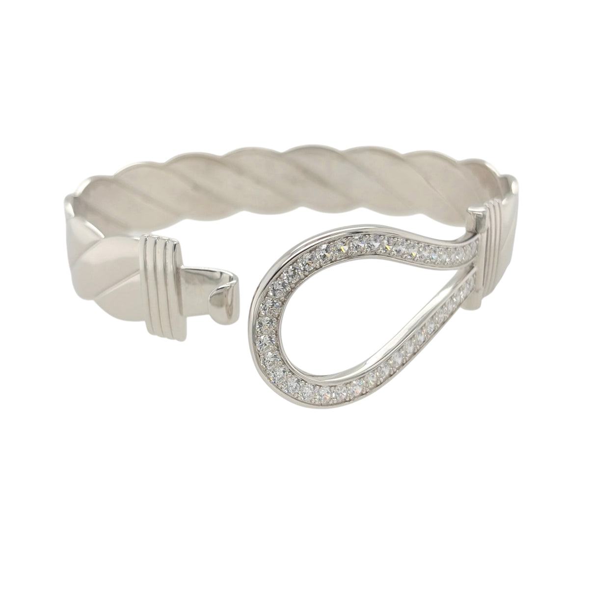 This new 925 sterling silver cubic zirconia set horseshoe twisted bangle is a substantial statement design, featuring a large horseshoe centrepiece with stone detailing.

Design: Featuring a twisted bangle design with a bold horseshoe centrepiece, this bangle has a polished silver finish with cubic zirconia detailing.
Material: Made from 925 sterling silver.
Gemstone Detail: Set with cubic zirconia stones across the horseshoe design.