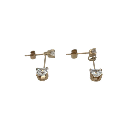 This pre-owned 9ct yellow gold cubic zirconia drop earrings are an elegant design, each featuring two square cubic zirconia stones in a delicate drop setting.

Design: Featuring a drop design with two square cubic zirconia stones on each earring, these earrings are finished in warm 9ct yellow gold.
Material: Made from 9-carat yellow gold.
Gemstone Detail: Each earring is set with two square cubic zirconia stones, with the lower stones measuring approximately 4mm by 4mm.