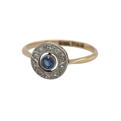 This pre-owned 18ct yellow gold and platinum diamond and sapphire Art Deco-style round cluster ring is a distinctive design, featuring a central sapphire surrounded by contrasting diamond detailing.

Design: Featuring an Art Deco-style round cluster design, this ring showcases a central sapphire surrounded by diamonds, with platinum detailing contrasting against the warm 18ct yellow gold.
Material: Made from 18-carat yellow gold and platinum.