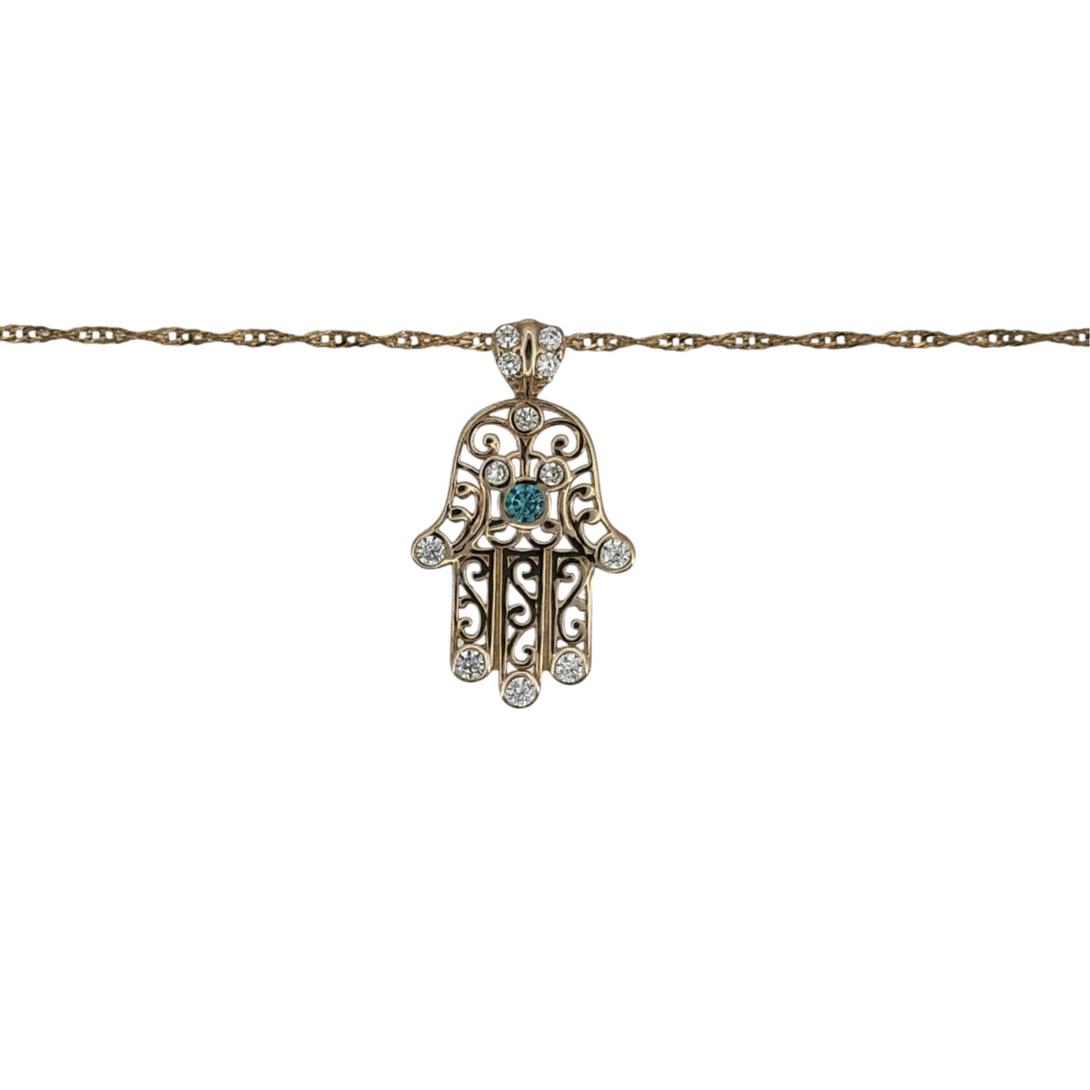 This pre-owned 9ct yellow gold cubic zirconia and blue stone set Hamsa Hand pendant necklace is a symbolic design, featuring colourful stone detailing on a delicate Singapore chain.
Design: Featuring a traditional Hamsa Hand motif, this pendant is decorated with cubic zirconia and blue stone detailing and finished in warm 9ct yellow gold.
Material: Made from 9-carat yellow gold.
Gemstone Detail: Set with cubic zirconia and blue stones within the Hamsa Hand design.