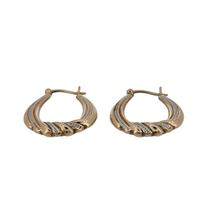 Add a stylish two-tone finish to your jewellery collection with these pre-owned 9ct yellow and white gold oval creole earrings, featuring an elegant twisted lower section and a classic wearable design.

Design: The earrings feature an oval creole shape with a decorative twist detail towards the bottom, combining contrasting yellow and white gold tones for an eye-catching two-tone finish.