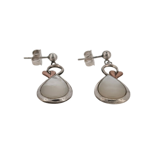 Bring natural beauty and symbolic elegance to your look with these pre-owned 925 silver and 9ct rose gold mother of pearl Clogau Tree of Life style drop earrings—perfect for adding grace and meaning to any occasion.

Design: Each earring features an elegant 13mm by 9mm oval mother of pearl stone, adorned with delicate Tree of Life detailing in warm 9ct rose gold. The lustrous pearl backdrop complements the intricate branches, symbolising growth, renewal, and connection.
