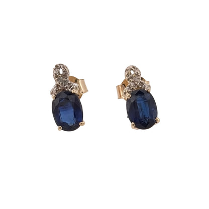 Add classic gemstone colour to your jewellery collection with these pre-owned 9ct yellow gold diamond and sapphire stud earrings, featuring oval sapphires complemented by diamond detailing.

Design: The earrings feature an elegant stud design, with an oval sapphire forming the central focal point of each earring and diamond detailing adding a classic finishing touch.
Material: Made from 9-carat yellow gold, the warm gold tone complements the rich colour of the sapphires and surrounding diamond accents.