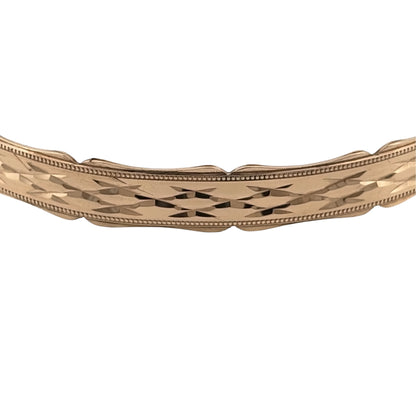 Add a substantial gold piece to your jewellery collection with this pre-owned 9ct yellow solid gold bangle, featuring decorative patterning and distinctive scalloped edges.

Design: The bangle features a patterned finish with scalloped edging, adding texture and decorative detail to the classic gold bangle design.
Material: Made from solid 9-carat yellow gold, the bangle has a warm gold finish and a substantial feel.