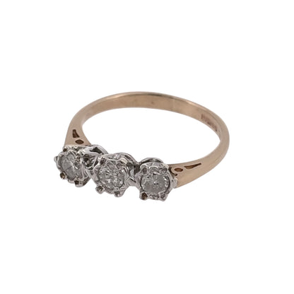 Add classic diamond detail to your jewellery collection with this pre-owned 9ct yellow gold trilogy ring, featuring three illusion-set diamonds in a timeless three-stone design.

Design: The ring features a traditional trilogy design, with three diamonds arranged across the front to create a balanced and elegant appearance.
Material: Made from 9-carat yellow gold, the warm gold tone provides a classic setting for the diamond detailing.