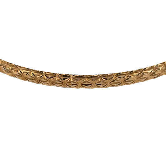 Add classic gold detail to your jewellery collection with this pre-owned 9ct yellow gold bangle, featuring a patterned textured finish for added character.

Design: The bangle features decorative patterning with a textured finish, adding detail and interest to the classic gold bangle design.
Material: Made from 9-carat yellow gold, the warm gold tone highlights the textured detailing and gives the bangle a timeless appearance.