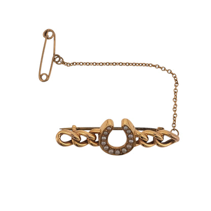 Add vintage character to your jewellery collection with this pre-owned 15ct yellow gold lucky horseshoe brooch or tie pin, featuring seed pearl detailing and a decorative curb link design.

Design: The piece features a traditional lucky horseshoe motif incorporated into a curb link design, creating a distinctive vintage-style accessory that can be worn as a brooch or tie pin.
