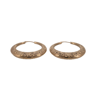 Add decorative gold detail to your jewellery collection with these pre-owned 9ct yellow gold flower patterned hoop creole earrings.

Design: The earrings feature a classic round hoop creole shape with decorative flower-patterned detailing, giving the design a distinctive finish.
Material: Made from 9-carat yellow gold, the warm gold tone highlights the floral pattern and complements the classic hoop style.