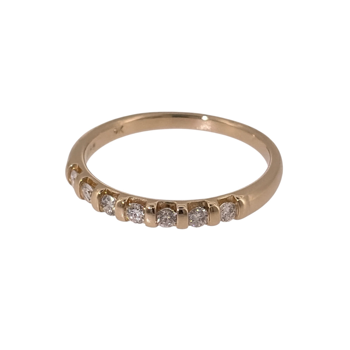 Add classic diamond detail to your jewellery collection with this pre-owned 9ct yellow gold seven-stone diamond band ring, featuring approximately 0.21ct of diamond content in total.

Design: The ring features a classic seven-stone band design, with the diamonds arranged neatly across the front for a timeless and versatile appearance.
Material: Made from 9-carat yellow gold, the warm gold tone provides a traditional setting for the row of diamonds.