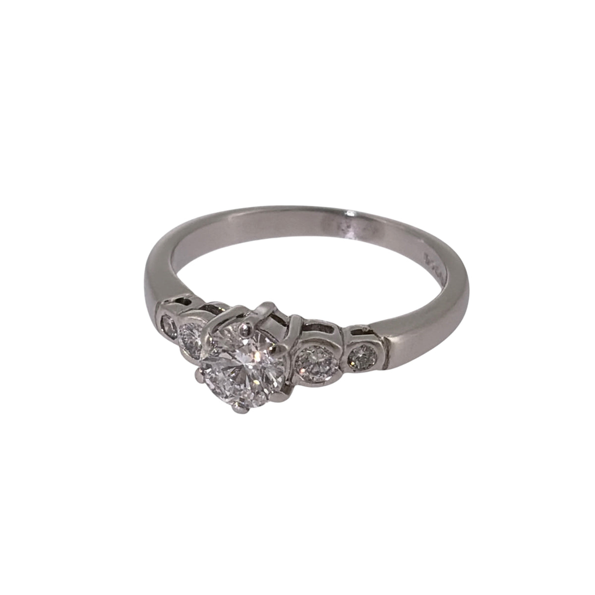 Add classic diamond elegance to your jewellery collection with this pre-owned platinum solitaire-style ring, featuring a larger central diamond complemented by four smaller diamonds.

Design: The ring features a solitaire-style design with a larger central diamond forming the focal point, accompanied by two smaller diamonds on each side for a total of five diamonds.
Material: Made from platinum, the naturally white metal provides a timeless setting that complements the diamond-set design.