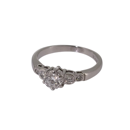 Add classic diamond elegance to your jewellery collection with this pre-owned platinum solitaire-style ring, featuring a larger central diamond complemented by four smaller diamonds.

Design: The ring features a solitaire-style design with a larger central diamond forming the focal point, accompanied by two smaller diamonds on each side for a total of five diamonds.
Material: Made from platinum, the naturally white metal provides a timeless setting that complements the diamond-set design.