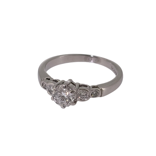 Add classic diamond elegance to your jewellery collection with this pre-owned platinum solitaire-style ring, featuring a larger central diamond complemented by four smaller diamonds.

Design: The ring features a solitaire-style design with a larger central diamond forming the focal point, accompanied by two smaller diamonds on each side for a total of five diamonds.
Material: Made from platinum, the naturally white metal provides a timeless setting that complements the diamond-set design.
