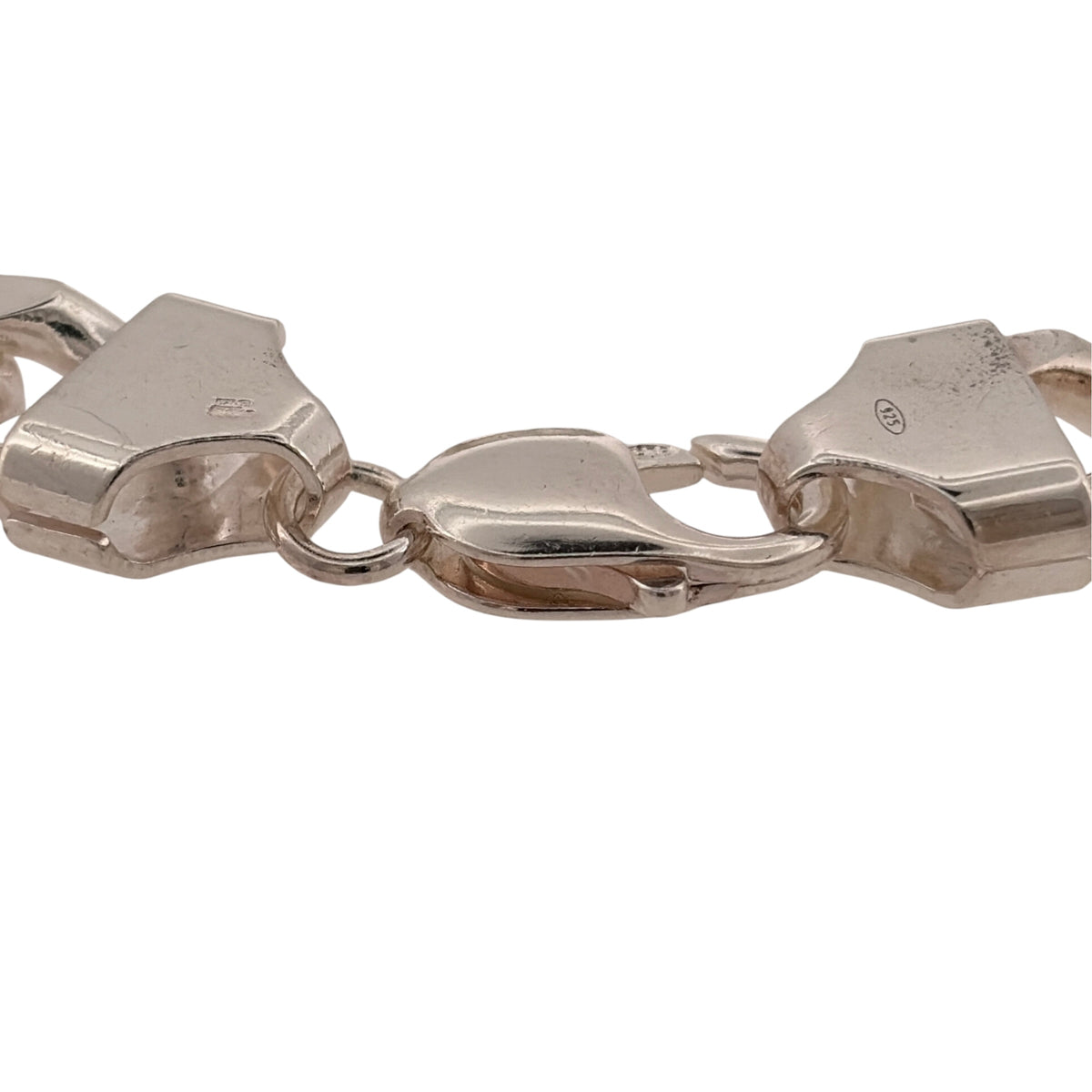 Add a bold silver piece to your jewellery collection with this pre-owned 925 sterling silver curb bracelet, featuring a substantial 12mm link width and classic design.

Design: The bracelet features a traditional curb link design, with its wide links creating a bold and timeless appearance suitable for wearing alone as a statement piece.
Material: Made from 925 sterling silver, the bright silver finish complements the classic curb link design.