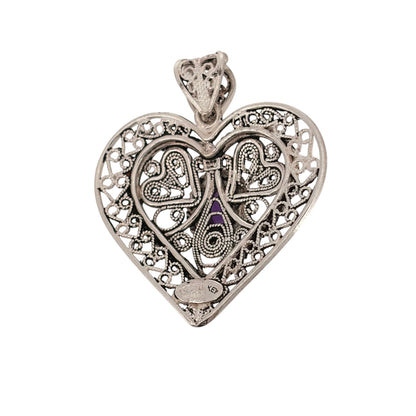 Add a decorative piece to your jewellery collection with this pre-owned 925 sterling silver open filigree heart pendant, featuring an oval purple stone and intricate detailing.

Design: The pendant features an open heart design with delicate filigree detailing, complemented by an oval purple stone for a colourful finishing touch.
Material: Made from 925 sterling silver.
Gemstone Detail: The oval purple stone measures approximately 8mm by 6mm, adding a lovely touch of colour to the design.