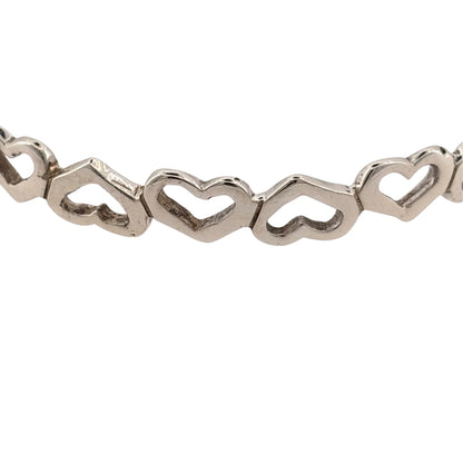 Add a charming piece to your jewellery collection with this pre-owned 925 sterling silver open heart bangle, featuring a decorative heart design and a classic silver finish.

Design: The bangle features an open heart design, creating a delicate and timeless appearance suitable for everyday wear or special occasions.
Material: Made from 925 sterling silver, complementing the elegant heart detailing.
