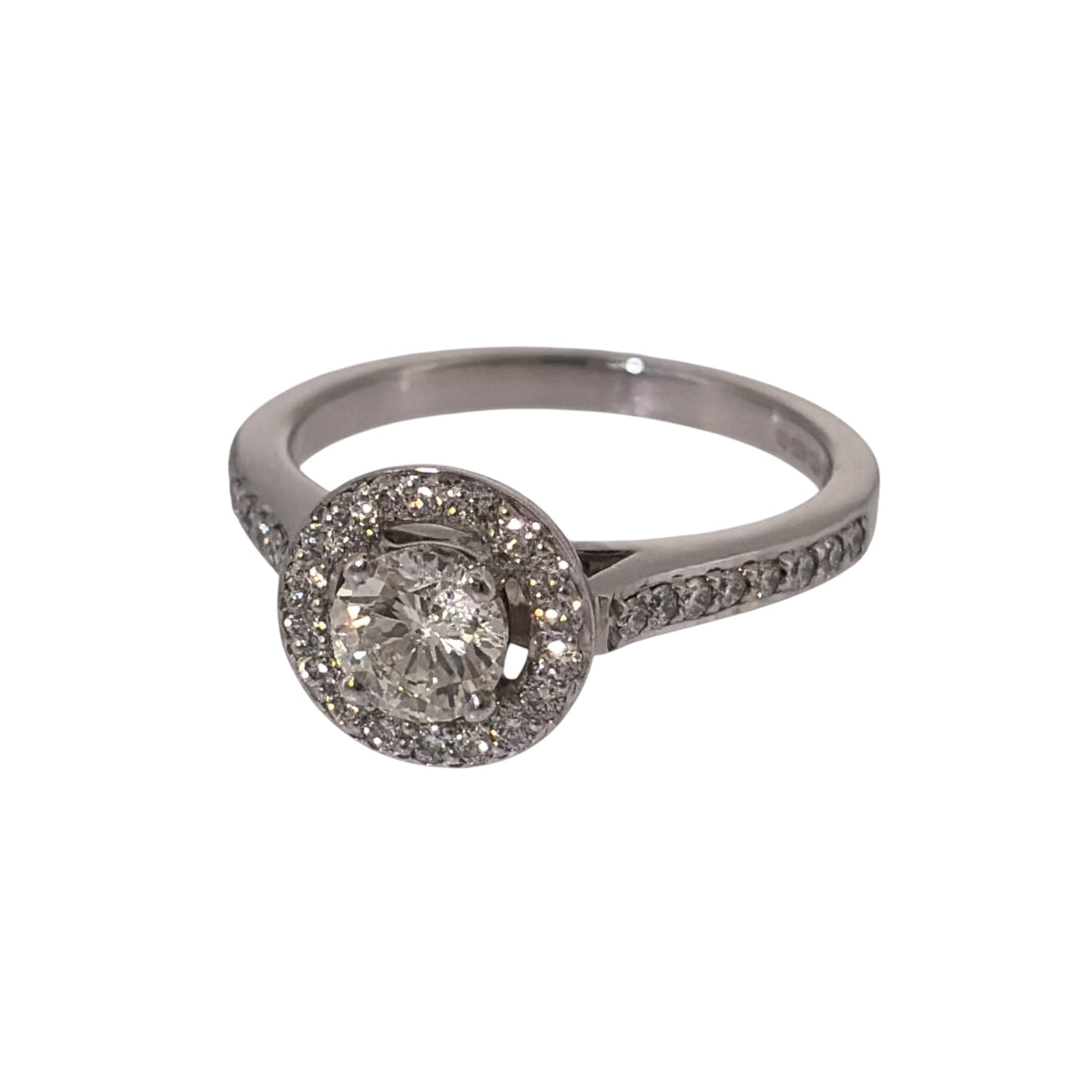 Add an elegant piece to your jewellery collection with this pre-owned 18ct white gold and diamond halo ring, featuring a central brilliant cut diamond weighing approximately 0.50ct, surrounded by smaller diamonds.

Design: The ring features a classic halo design, with a central brilliant cut diamond surrounded by smaller diamonds and additional diamonds set along half of the band, creating a decorative and timeless appearance.