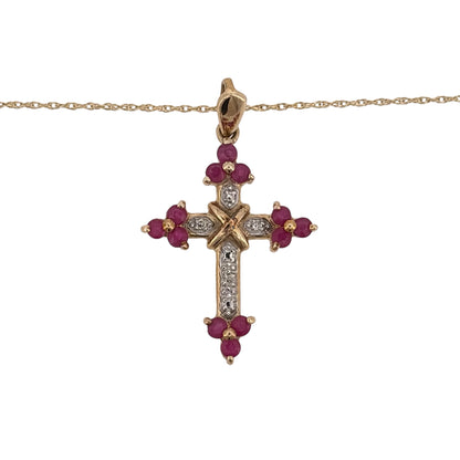 Add a meaningful piece to your jewellery collection with this pre-owned 9ct yellow gold diamond and ruby cross pendant necklace, featuring a decorative cross design on an 18-inch Prince of Wales chain.

Design: The necklace features a traditional cross pendant with diamond and ruby detailing, creating an elegant design that combines religious symbolism with colourful gemstones.
Material: Made from 9ct yellow gold, offering a warm gold finish that complements the diamonds and rubies.