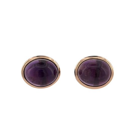 Add a colourful piece to your jewellery collection with these pre-owned 14ct yellow gold and purple stone oval stud earrings, featuring large oval purple stones in a classic design.

Design: The earrings feature a traditional oval stud design, with purple stones creating an elegant and noticeable appearance.
Material: Made from 14ct yellow gold, offering a warm gold finish that complements the purple stones.