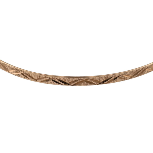 Add a classic touch to your jewellery collection with this pre-owned 9ct yellow solid gold patterned bangle, featuring decorative detailing and a timeless design.

Design: The bangle features a traditional patterned finish, adding subtle detail to its simple and elegant appearance.
Material: Made from solid 9ct yellow gold, offering a classic warm gold finish.
Bangle Detail: The bangle measures approximately 3mm wide, with a diameter of 6.7cm, creating a delicate and versatile appearance on the wrist.