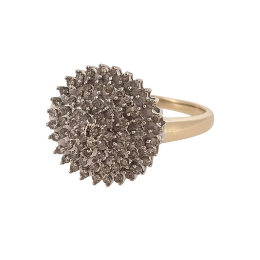 Make a statement with this pre-owned 9ct yellow gold and diamond large round cluster ring, featuring a bold circular design with decorative diamond detailing.

Design: The ring features a traditional round cluster design, with diamonds arranged to create a prominent and eye-catching appearance.
Material: Made from 9ct yellow gold, offering a classic warm gold finish.
Diamond Detail: Features diamonds set within the large round cluster, adding an elegant finishing touch to the design.