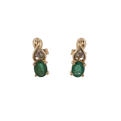 Add an elegant touch of colour to your jewellery collection with these pre-owned 9ct yellow gold diamond and emerald stud earrings, featuring beautiful oval emerald stones complemented by diamond detailing.

Design: The earrings feature a classic stud design, combining oval emerald stones with diamonds for an elegant and timeless appearance.
Material: Made from 9ct yellow gold, offering a warm gold finish that complements the green emeralds.