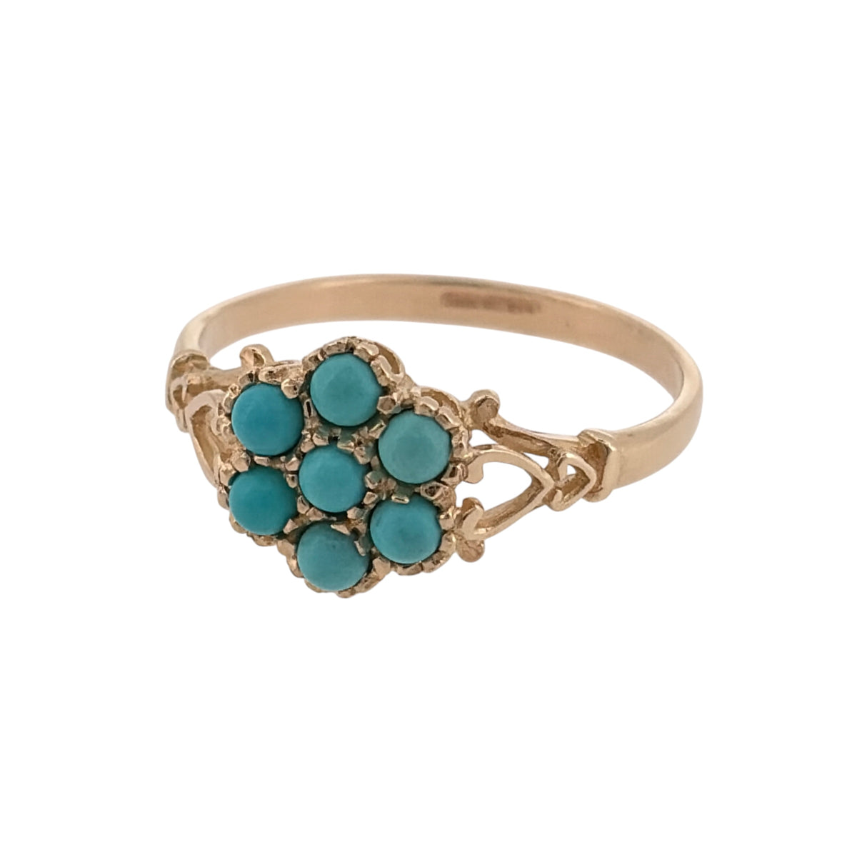 Add a colourful and charming piece to your jewellery collection with this pre-owned 9ct yellow gold and turquoise flower cluster ring, featuring a decorative floral design with heart-shaped cut-out detailing on the shoulders.

Design: The ring features a flower cluster design, with turquoise stones arranged to create an attractive floral appearance.
Material: Made from 9ct yellow gold, offering a traditional warm gold finish that complements the blue tones of the turquoise.