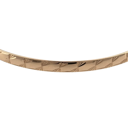 Add a timeless piece to your jewellery collection with this pre-owned 9ct yellow solid gold patterned bangle, featuring decorative detailing and a classic gold finish.

Design: The bangle features a traditional circular design with patterned detailing, creating an attractive and elegant appearance.
Material: Made from solid 9ct yellow gold, offering a classic warm gold finish.
Bangle Detail: The bangle measures approximately 4mm wide, with decorative patterned detailing that adds character to the design.