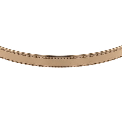 Add a classic piece to your jewellery collection with this pre-owned 9ct yellow solid gold milgrain edge bangle, featuring delicate decorative edging and a timeless gold finish.

Design: The bangle features a traditional circular design with milgrain detailing along the edges, creating an elegant and decorative appearance.
Material: Made from solid 9ct yellow gold, offering a classic warm gold finish.