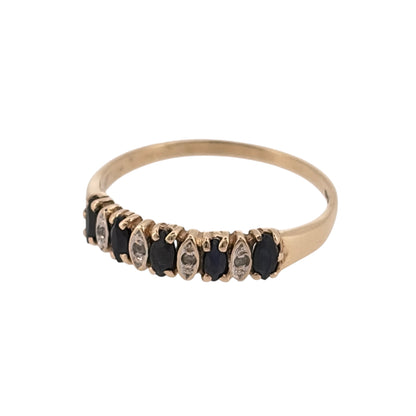 Add a classic touch of colour to your jewellery collection with this pre-owned 9ct yellow gold diamond and sapphire band ring, featuring marquise cut sapphires complemented by delicate diamond detailing.

Design: The ring features an elegant band design with marquise cut sapphires arranged across the front, separated by small diamonds for an attractive and timeless appearance.
Material: Made from 9ct yellow gold, offering a traditional warm gold finish that complements the blue tones of the sapphires.