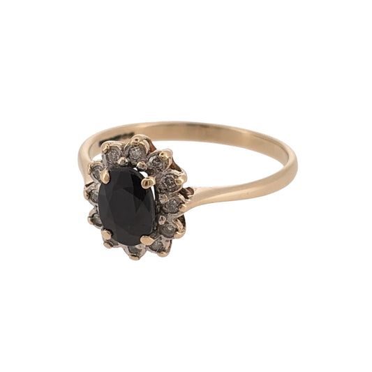 Add a classic touch of colour to your jewellery collection with this pre-owned 9ct yellow gold diamond and sapphire cluster ring, featuring a beautiful oval sapphire surrounded by diamonds.

Design: The ring features a traditional cluster design, with a central oval sapphire surrounded by diamonds, creating an elegant and timeless appearance.
Material: Made from 9ct yellow gold, offering a warm gold finish that complements the blue tones of the sapphire.