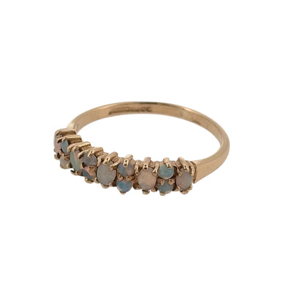 Add a delicate touch of colour to your jewellery collection with this pre-owned 9ct yellow gold and opalique cluster band ring, featuring decorative opalique stones in a classic gold design.

Design: The ring features a traditional cluster band design, with opalique stones arranged across the front to create an attractive and elegant appearance.
Material: Made from 9ct yellow gold, offering a classic warm gold finish that complements the colourful tones of the opalique stones.