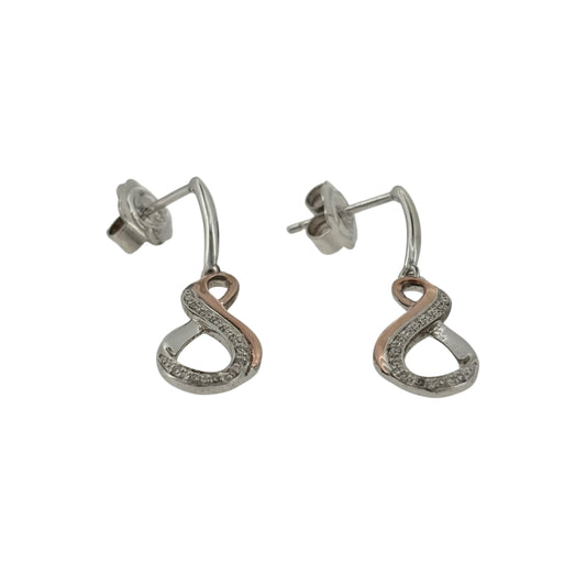 Add an elegant and meaningful touch to your jewellery collection with these pre-owned Clogau infinity drop earrings, combining 925 sterling silver, 9ct rose gold and diamond detailing in a timeless design.

Design: The earrings feature a decorative infinity design in an elegant drop style, symbolising everlasting love and connection.
Material: Made from 925 sterling silver with 9ct rose gold detailing, offering an attractive contrasting two-tone finish.