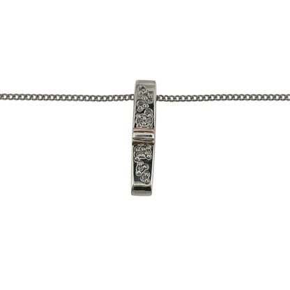 Add a contemporary touch to your jewellery collection with this pre-owned Clogau diamond bar pendant necklace, combining 925 sterling silver, 9ct rose gold and diamond detailing in an elegant and versatile design.

Design: The necklace features a sleek bar-shaped pendant with decorative diamond detailing, creating a modern and timeless appearance.
Material: Made from 925 sterling silver with 9ct rose gold detailing, offering an attractive contrasting two-tone finish.