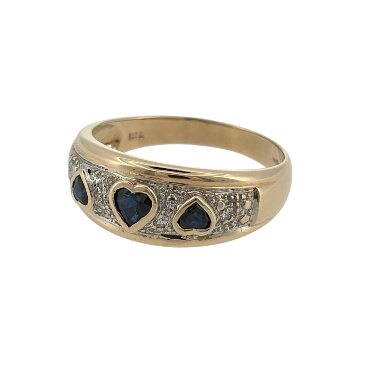 Add a charming touch of colour to your jewellery collection with this pre-owned 9ct yellow gold diamond and sapphire heart band ring, featuring three heart-shaped sapphires complemented by elegant diamond detailing.

Design: The ring features a decorative band design with three heart-shaped sapphire stones, creating an attractive and sentimental appearance.
Material: Made from 9ct yellow gold, offering a classic warm gold finish that complements the rich blue tones of the sapphires.