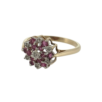 Add a beautiful touch of colour to your jewellery collection with this pre-owned 9ct yellow gold diamond and ruby cluster ring, featuring an attractive arrangement of small rubies and diamonds in a classic gold design.

Design: The ring features a traditional cluster design, with multiple small rubies and diamonds arranged together to create an elegant and decorative appearance.
Material: Made from 9ct yellow gold, offering a warm gold finish that complements the rich red tones of the rubies.