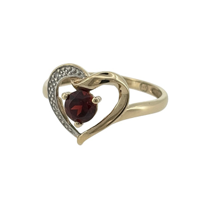 Add a romantic touch to your jewellery collection with this pre-owned 9ct yellow gold diamond and garnet heart ring, featuring a beautiful round garnet stone complemented by diamond detailing.

Design: The ring features a charming heart-inspired design, combining a round garnet with diamonds to create an elegant and sentimental appearance.
Material: Made from 9ct yellow gold, offering a classic warm gold finish that complements the rich red tones of the garnet.