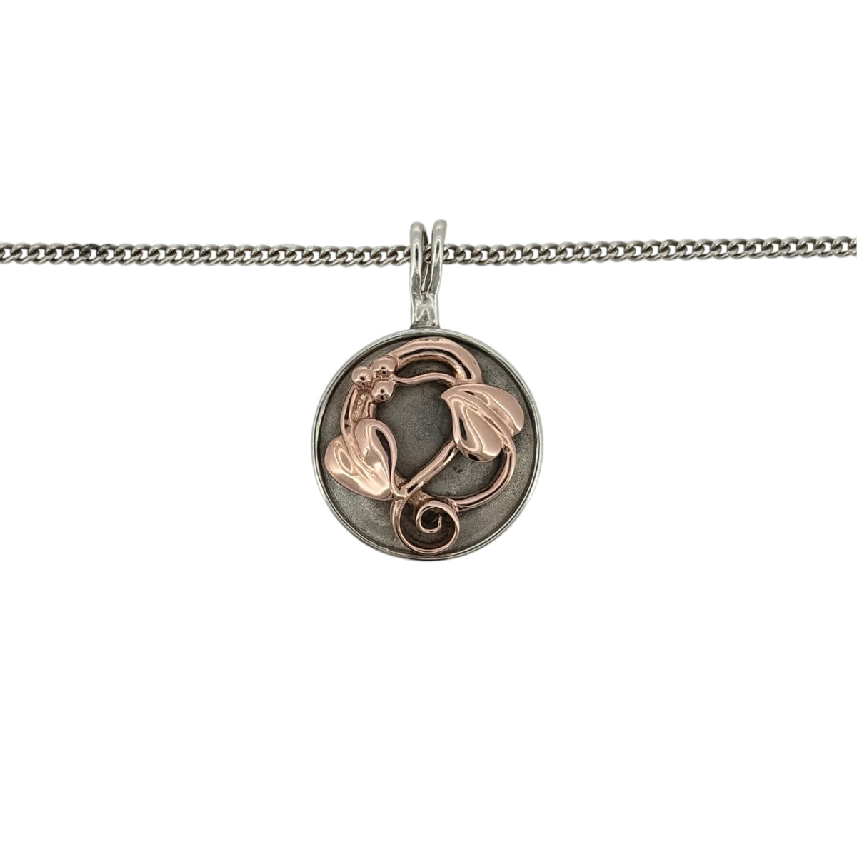 Add a meaningful touch to your jewellery collection with this pre-owned Clogau Tree of Life round pendant necklace, featuring a beautiful combination of 925 sterling silver and 9ct rose gold detailing, suspended from a classic 18-inch curb chain.

Design: The necklace features the iconic Clogau Tree of Life design within a round pendant, combining decorative nature-inspired detailing with contrasting silver and rose gold tones to create an elegant and symbolic appearance.