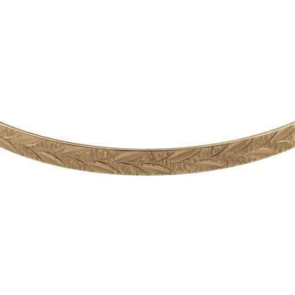 Add a timeless touch to your jewellery collection with this pre-owned 9ct solid yellow gold patterned bangle, featuring decorative detailing in a classic warm gold finish.

Design: The bangle features an elegant patterned design, with decorative detailing creating an attractive and distinctive appearance.
Material: Made from solid 9ct yellow gold, offering a traditional warm gold finish that beautifully complements the patterned design.