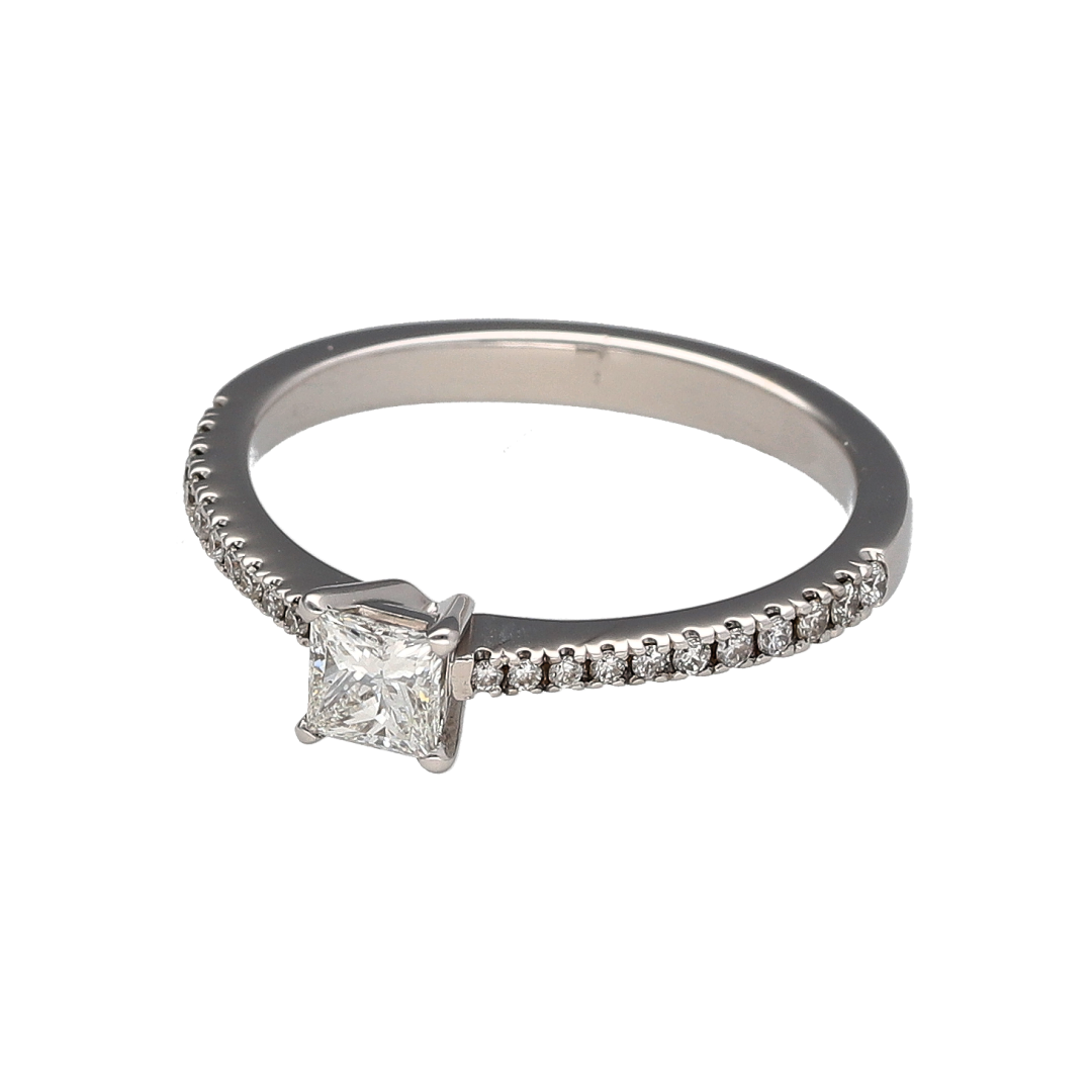 Showcasing exceptional sparkle and contemporary elegance, this pre-owned 18ct white gold diamond solitaire ring is a timeless piece designed to make an impression. Featuring a stunning princess-cut centre diamond complemented by diamond-set shoulders, this ring combines classic luxury with modern sophistication.

Design: The ring is centred by a beautiful princess-cut diamond, admired for its clean lines, square shape, and outstanding brilliance.