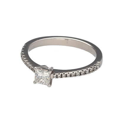 Showcasing exceptional sparkle and contemporary elegance, this pre-owned 18ct white gold diamond solitaire ring is a timeless piece designed to make an impression. Featuring a stunning princess-cut centre diamond complemented by diamond-set shoulders, this ring combines classic luxury with modern sophistication.

Design: The ring is centred by a beautiful princess-cut diamond, admired for its clean lines, square shape, and outstanding brilliance.