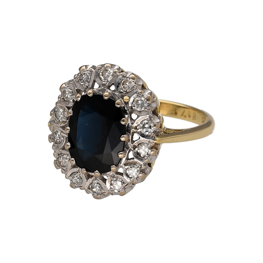 Elegant and timeless, this pre-owned 18ct yellow gold diamond and sapphire cluster ring is a stunning statement piece that showcases the classic beauty of a richly coloured sapphire surrounded by sparkling diamonds. Crafted in luxurious 18-carat gold, it is a sophisticated choice for special occasions or as a treasured addition to any jewellery collection.

Design: The ring features a classic cluster setting with a striking oval sapphire at its centre, framed by a halo of sparkling diamonds.