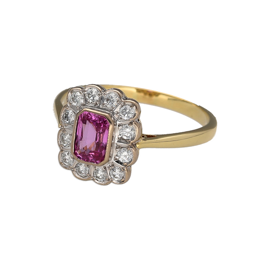 Luxurious and feminine, this pre-owned 18ct yellow gold diamond and pink sapphire cluster ring is a stunning piece that beautifully combines the soft blush tones of a vibrant pink sapphire with the brilliance of sparkling diamonds. Its elegant cluster design creates a timeless statement, perfect for special occasions or everyday sophistication.

Design: The ring features a striking rectangular pink sapphire at its centre, surrounded by a sparkling halo of diamonds