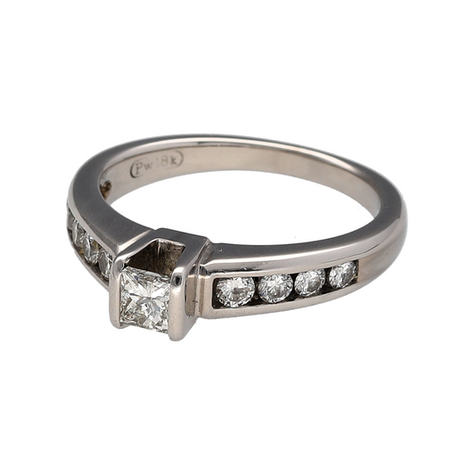 Add timeless elegance and refined sparkle to your jewellery collection with this pre-owned 18ct white gold and diamond solitaire ring, featuring a princess cut centre diamond complemented by brilliant cut diamond detailing along the band.

Design: The ring showcases an elegant solitaire-style design centred around a princess cut diamond, with brilliant cut diamonds set across half of the band to create additional sparkle and visual interest while retaining a timeless and sophisticated appearance.