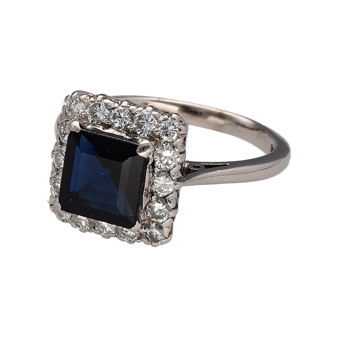 Add rich colour and luxurious sparkle to your jewellery collection with this pre-owned 18ct white gold diamond and sapphire cluster ring, featuring a striking square sapphire surrounded by sparkling diamonds—perfect as a statement ring, engagement ring, anniversary gift, or elegant piece for special occasions.

Design: The ring features a classic cluster design centred with a square sapphire, surrounded by sparkling diamonds that create an eye-catching frame and enhance the rich colour of the centre stone.