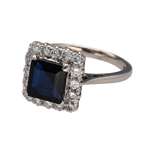 Add rich colour and luxurious sparkle to your jewellery collection with this pre-owned 18ct white gold diamond and sapphire cluster ring, featuring a striking square sapphire surrounded by sparkling diamonds—perfect as a statement ring, engagement ring, anniversary gift, or elegant piece for special occasions.

Design: The ring features a classic cluster design centred with a square sapphire, surrounded by sparkling diamonds that create an eye-catching frame and enhance the rich colour of the centre stone.