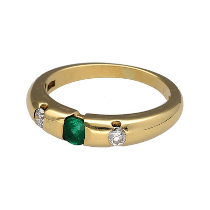 This pre-owned 18ct yellow gold diamond and emerald band ring is a classic gemstone design, featuring a central oval emerald with a diamond set on either side.

Design: Featuring an oval emerald as the centre stone with a diamond set either side, this ring combines rich gemstone colour with the warm finish of 18ct yellow gold.
Material: Made from 18-carat yellow gold.
Gemstone Detail: Centre oval emerald measures approximately 4mm by 3mm, with two diamonds totalling approximately 0.20ct.