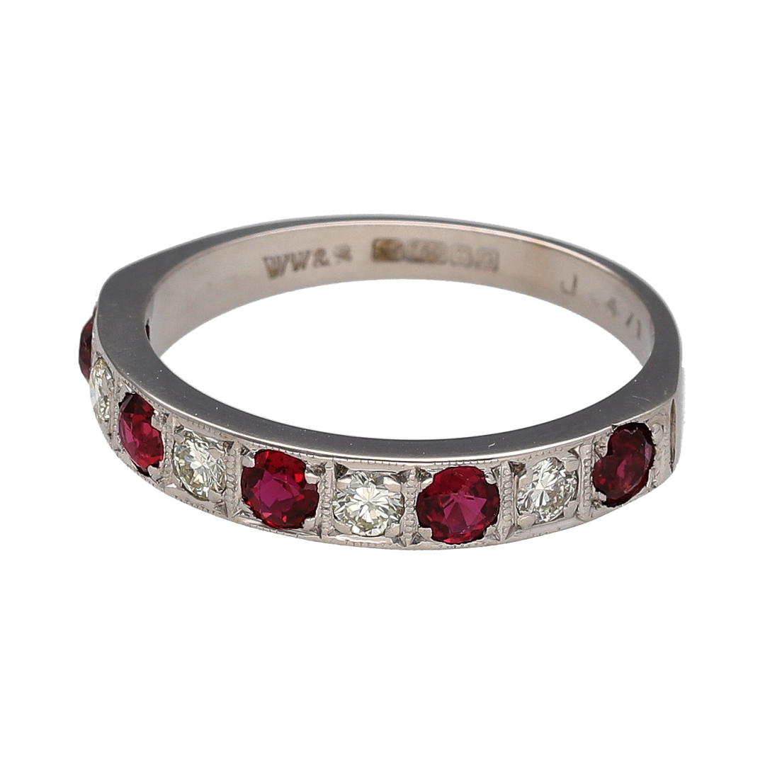 This pre-owned 18ct white gold diamond and ruby band ring is a classic design, featuring round rubies with diamond detailing set between.

Design: Featuring an alternating gemstone design, this ring combines round rubies with diamonds across the front of the band in 18ct white gold.
Material: Made from 18-carat white gold.
Gemstone Detail: Set with round rubies measuring approximately 3mm in diameter, with approximately 0.24ct of diamond content set between.