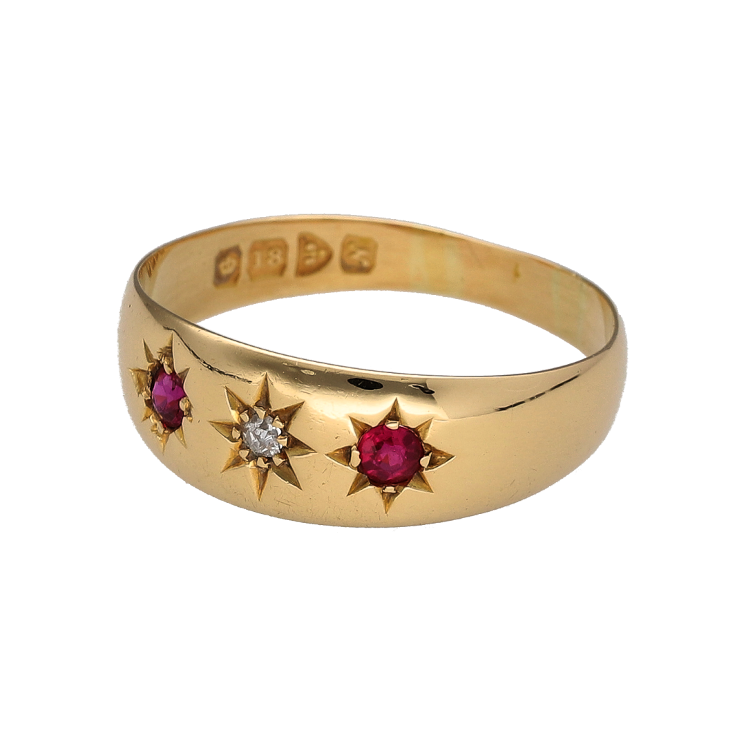 Discover a piece of early 20th-century jewellery with this pre-owned 18ct yellow gold diamond and ruby band ring, featuring a central diamond flanked by two rubies and a Chester hallmark dating the ring to approximately 1913–1914.

Design: The ring features a traditional three-stone arrangement with a diamond at the centre and a ruby positioned on either side, creating a classic combination of rich red colour and diamond detail.